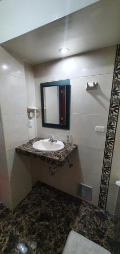 a bathroom with a sink and a mirror at Cusco Apartment MVP in Cusco