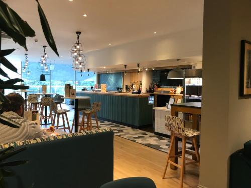 a kitchen and dining room with a table and chairs at Holiday Inn Rugby-Northampton M1 Jct18 by IHG in Crick