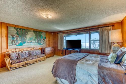 a bedroom with a large bed and a television at The Bridge and Balcony in North Bend