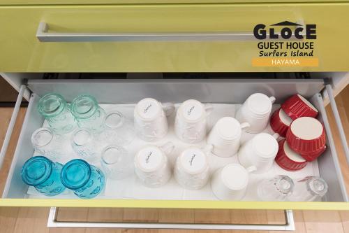a shelf with a bunch of cups and bowls at GLOCE 葉山 サーファーズログハウス l HAYAMA Surfers Log house in Hayama