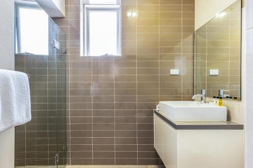 a bathroom with a sink and a mirror at Leichhardt Self-Contained Modern One-Bedroom Apartment (9NOR) in Sydney
