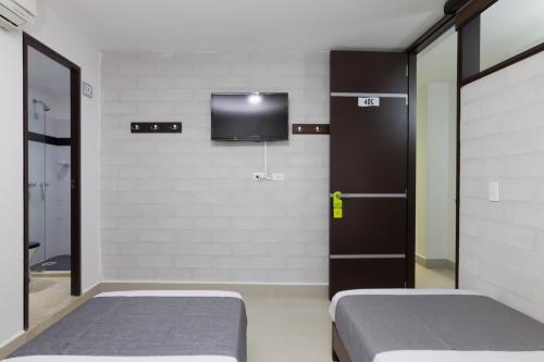 Postel nebo postele na pokoji v ubytování Ayenda 1254 Mi Colombia