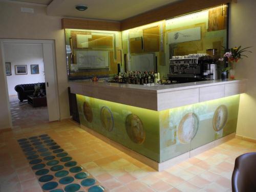a bar in a room with a counter with wine bottles at Il Casale Della Stella in Baronissi