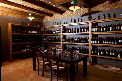 a wine tasting room with a table and shelves of wine bottles at Il Casale Della Stella in Baronissi
