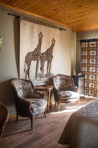two giraffes mural on the wall in a bedroom at Lagoon Lodge in Walvis Bay