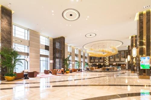 a lobby of a hotel with a large building at Holiday Inn Shanghai Hongqiao by IHG - near by Hongqiao Airport & NECC in Shanghai