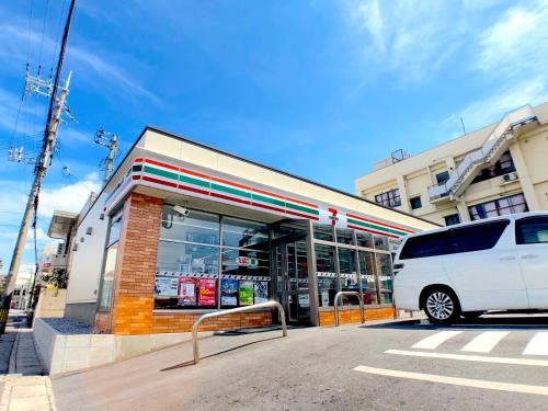 a white van parked in front of a gas station at Luana Lea Karate Kaikan Mae in Tomigusuku