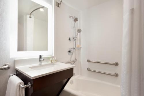 a white bathroom with a sink and a shower at Holiday Inn Rock Island-Quad Cities by IHG in Rock Island