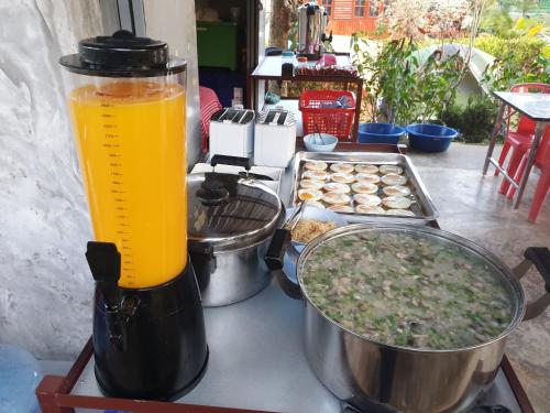 a blender sitting on a table with some food at Khao Kho Lucky Hill Resort in Khao Kho