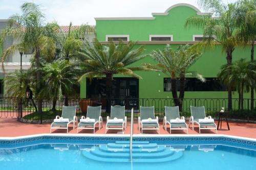 a group of chairs sitting next to a swimming pool at Holiday Inn Tampico-Altamira, an IHG Hotel in Tampico