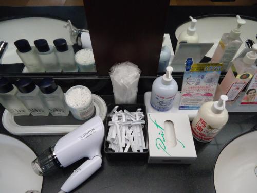 a counter with a hair dryer and other bathroom items at Yamagisi Ryokan in Fujikawaguchiko
