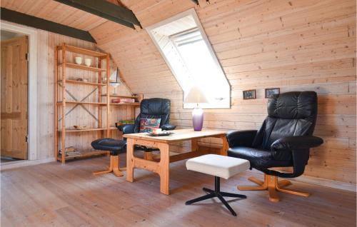 a room with two chairs and a desk and a window at 3 Bedroom Nice Home In Ulfborg in Ulfborg