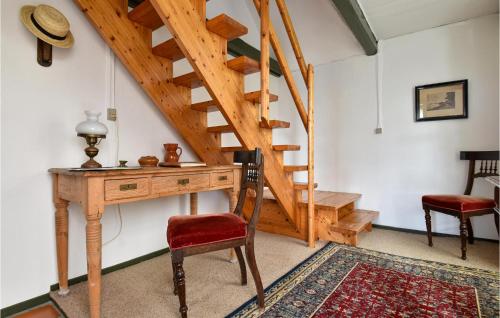 a room with a wooden desk and a staircase at 3 Bedroom Nice Home In Ulfborg in Ulfborg