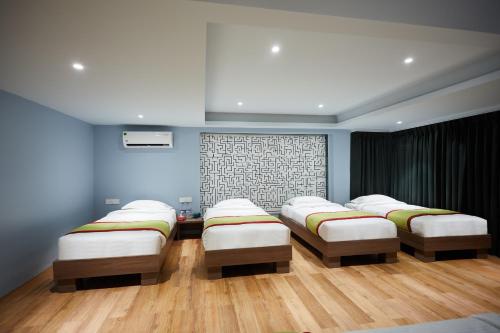 a room with four beds in a room at Aureole Mrida - A Boutique Hotel in Lonavala