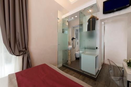 a bathroom with a glass shower with a toilet at Hotel Navona in Rome