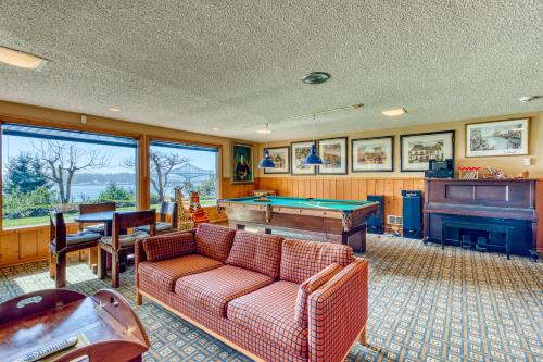 a living room with a couch and a pool table at The Bridge and Balcony in North Bend