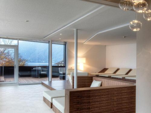 a hotel room with two beds and a balcony at Seehotel Waldstätterhof Swiss Quality in Brunnen