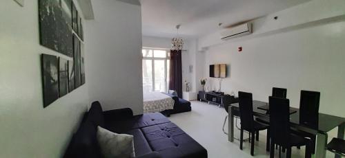 a living room with a couch and a dining room at Pico de Loro Jacana B in Nasugbu