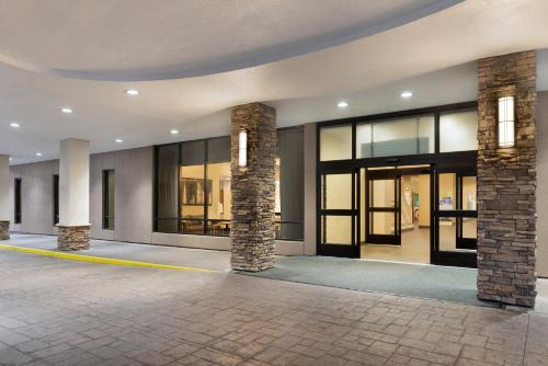 an empty lobby with glass doors and stone pillars at Holiday Inn Rock Island-Quad Cities by IHG in Rock Island