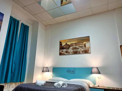 a bedroom with a bed with a blue headboard at Hotel Youri Il Magnifico in Genova
