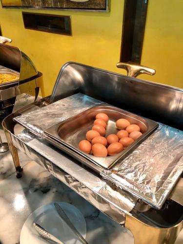 a tray of eggs on a counter in a kitchen at Rose View Hotel in Sylhet