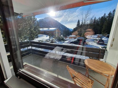 a balcony with a view of a snow covered mountain at Apartment in Lenzerheide in Lenzerheide
