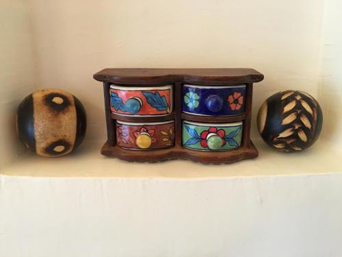a shelf with three vases and a box on it at Djorff Palace in Luxor