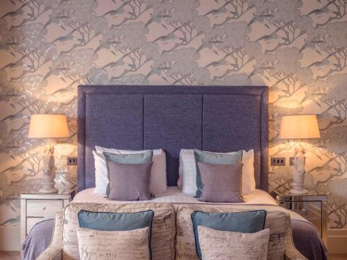 a bedroom with a large bed with two lamps at Clifton Arms Hotel in Lytham St Annes