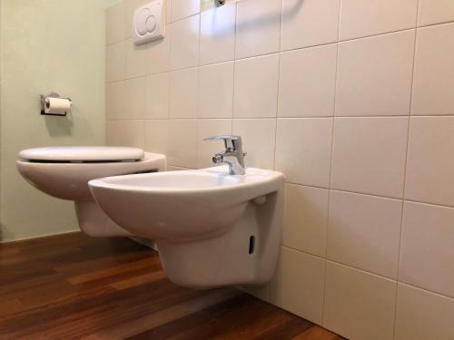 a bathroom with a toilet and a sink at Lacisivm Lake View in Lazise