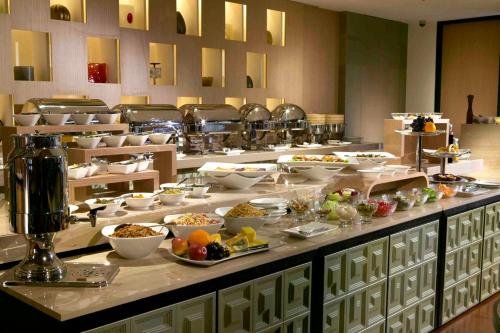 a buffet line with many bowls of food on it at City Suites-Taipei Nanxi in Taipei