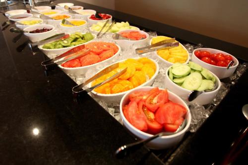 a buffet with many bowls of different fruits and vegetables at Crowne Plaza Reading in Reading
