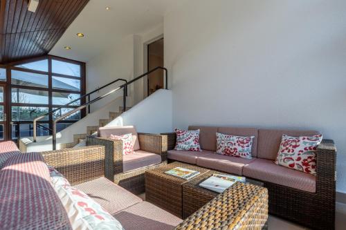 a living room with a couch and a table at Jagdschloss Hotel Niederwald in Rüdesheim am Rhein