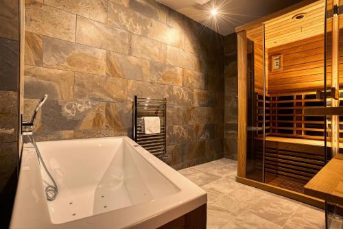 a bathroom with a large tub and a glass shower at Apartmán Polana in Demanovska Dolina