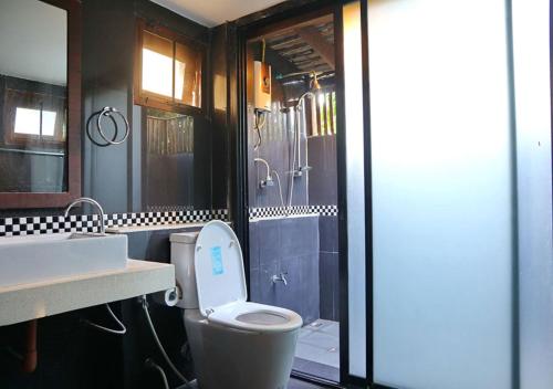 a bathroom with a toilet and a sink at Aurora Resort Chiangdao in Chiang Dao