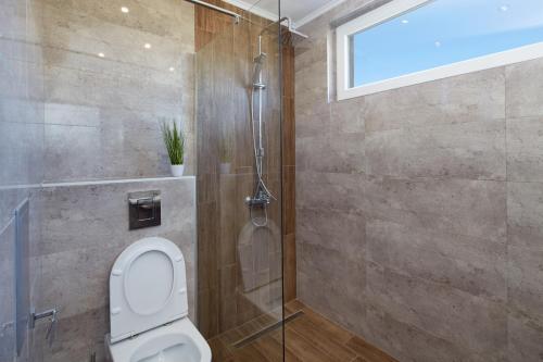 a bathroom with a toilet and a shower at Niko's Sea View Apartments Deluxe in Nesebar