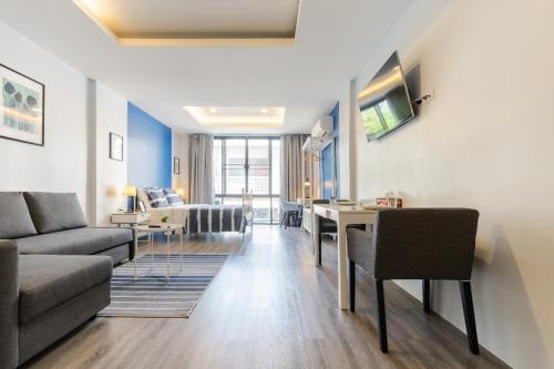 a living room with a couch and a table at Cozy Studio 1 in Sathorn, BTS Saint Louis in Bangkok