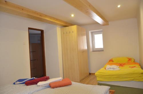 a small room with two beds and a window at Domcek Lutila 54 in Lutila