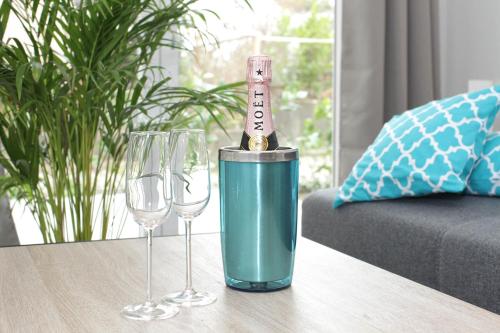 a bottle of wine in a bucket on a table with two wine glasses at Voss-Haus in Eutin