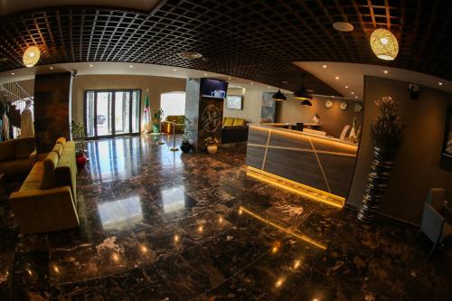 a room with a lobby with lights on the floor at Hotel Messaoudi in Batna