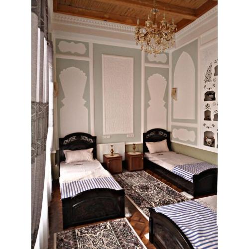 Ένα ή περισσότερα κρεβάτια σε δωμάτιο στο Rahmat guesthouse