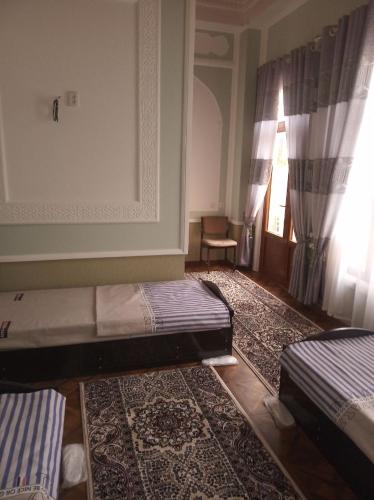 Ένα ή περισσότερα κρεβάτια σε δωμάτιο στο Rahmat guesthouse