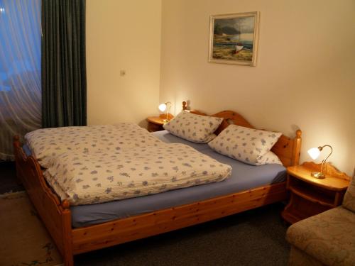 a bedroom with a bed with two pillows on it at Landhaus Lena in Schönwald