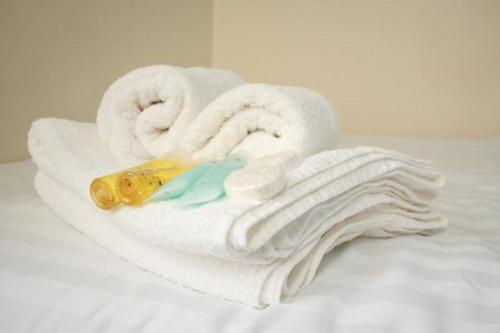 a pile of white towels on a bed at The Quigley Residence in Limerick