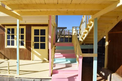 a set of stairs on a house with a yellow door at Sina Star Camp in Nuweiba