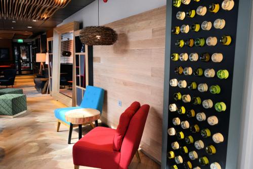 a room with a wall filled with wine bottles at Holiday Inn Tampere - Central Station by IHG in Tampere
