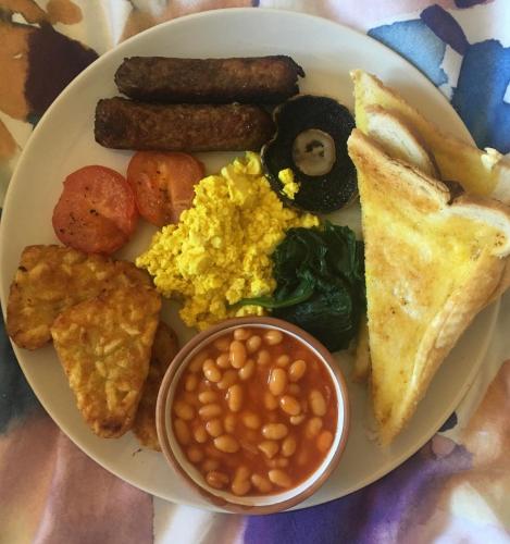 a plate of breakfast food with eggs sausage beans and toast at Black Sheep Inn and Spa in Hammondsport