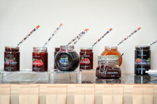 a counter with jars of jam and jars of honey at Erlenhof B&B in Kötschach
