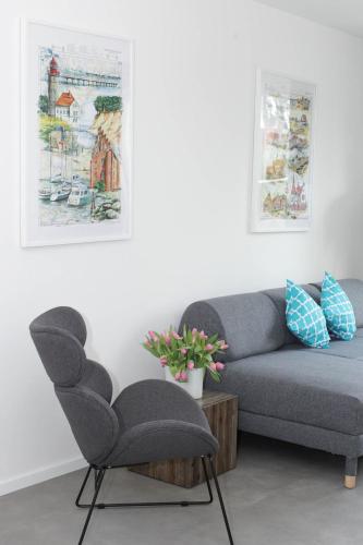 a living room with a couch and a chair at Voss-Haus in Eutin