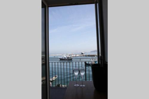 a room with a window with a view of the ocean at L angolo segreto di Giovanni il Pescatore in Procida