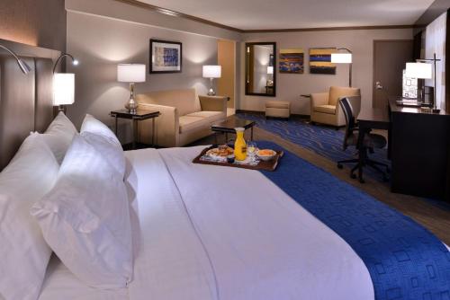 a large white bed in a hotel room at The Arch Convention Hotel in Saint Louis